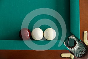 A pool table. Top view. The ball rolls into the pocket.