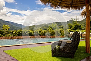 Pool villa resort landscape design and decoration with beach chair and umbrella, wooden chair on patio