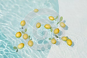 Pool Water With Lemons. Pure Aqua Surface With Glares Pattern And Floating Fresh Citrus.