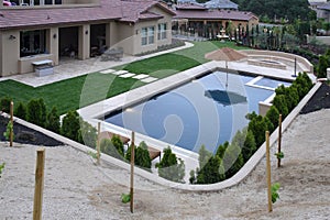 A pool with a waterfall in a luxury backyard