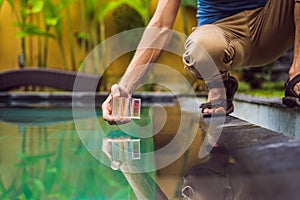 Pool worker checks the pool for safety. Measurement of chlorine and PH of a pool