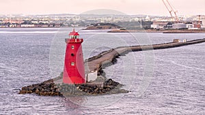 Poolbeg Lighthouse the famous red landmark in Dublin Harbor Ireland seen in the morning