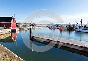 Poole harbour and quay Dorset England UK on a beautiful calm day with boats and blue sky