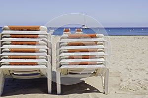 Pooled chaise lounges on the beach