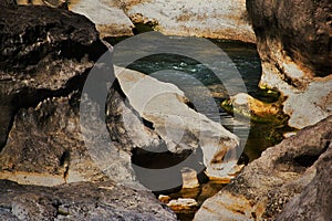 Pooling Water Surrounded by Rock and Boulders