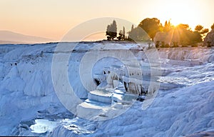 Pools of Pamukkale in Turkey in sunset, contains hot springs and travertines, terraces of carbonate minerals left by water