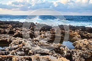 Pools of water in rocks on a beach in Qawra