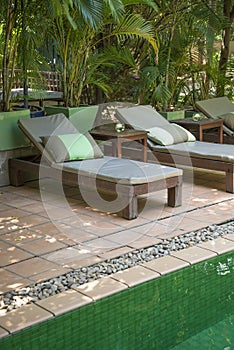 Poolside deck chairs detail in tropical resort