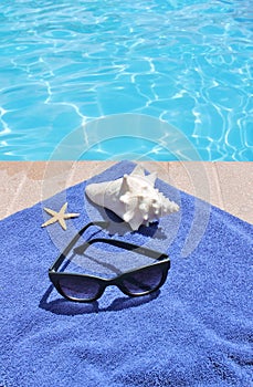 Poolside holiday scenic shell towel sunglasses vacation background