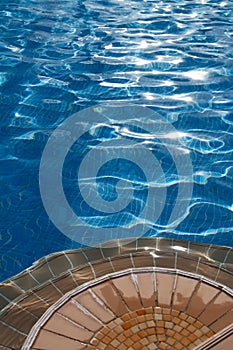 Poolside with steps and clean blue water