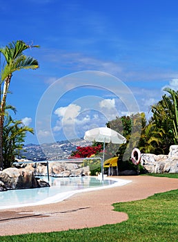 Poolside with umrella and sea view. Canary Islands. Spain.Canary Islands.Spain.