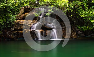 Poolside waterfall in a beautiful garden setting