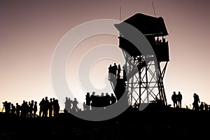 Poonhill view point tower in the morning before sunrise. Silhouettes of trekkers and lookout tower. Poon Hill, Himalayas