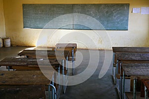 Poor african classroom with empty desks