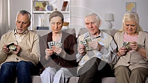Poor aged couples counting dollars at home, lack of money, social insecurity