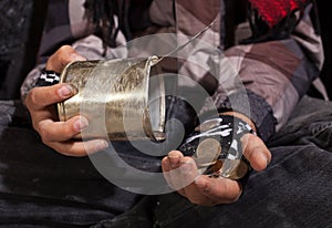 Poor beggar child counting coins - closeup on hands