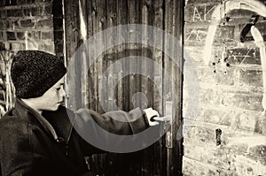 Poor boy opens door of his home