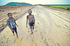 Poor cambodian kids playing in mud