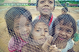 Poor cambodian kids playing with trawl