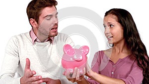 Poor couple with moving box and piggy bank