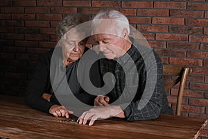 Poor elderly couple counting coins