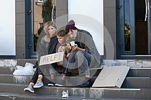 Poor homeless family begging and asking for help
