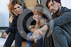 Poor homeless family begging photo