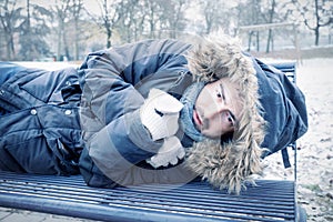 Poor homeless man suffering cold during winter weather season