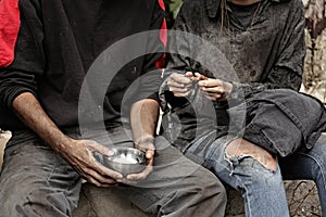 Poor homeless people sharing piece of bread