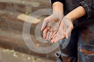 Poor homeless woman begging for help outdoors