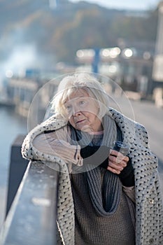 Poor homeless woman having no food but drinking hot tea