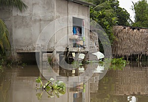 Poor house on wooden stilts at Mekong River