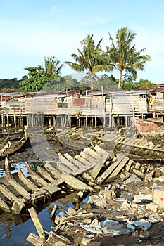 Poor houses and wreckage of boats