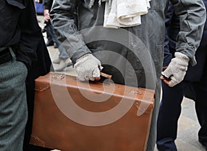 poor immigrant with old leather suitcase during the trip abroad