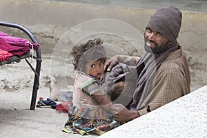 Poor Indian beggar family on street in Ladakh. India