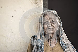 Poor lady looking at camera