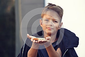 Poor little boy with bread on street