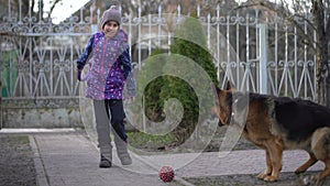 poor little girl with a dog in village