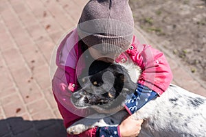 poor little girl with a dog in village