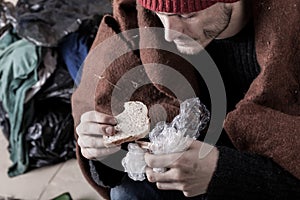 Poor man eating sandwich