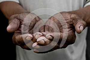 The poor old man`s hands beg you for help. The concept of hunger or poverty.