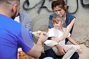 Poor people receiving food from volunteer