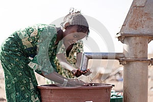 Poor West Africa Youngster with pure Water in a rural village