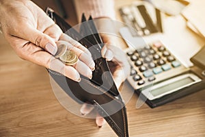 Poor woman hand holding coin after payday, bankruptcy broke