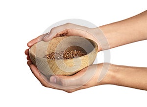 Poor woman holding bowl with grains