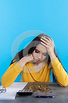 A poor young girl counts money at home at her desk, hoping that she will have enough for all expenses