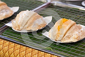 Poorman`s Pancakes with coconut and sugar on tray for sale in Th