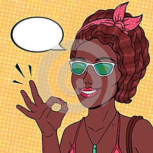 Pop art african american woman smiling and showing OK hand sign, speech bubble for message. Vector comics afro woman in pink