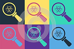 Pop art Biohazard and magnifying glass icon isolated on color background. Vector