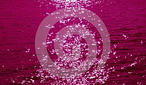 Pop art style magenta pink colored sparkling water surface with the sea ripples